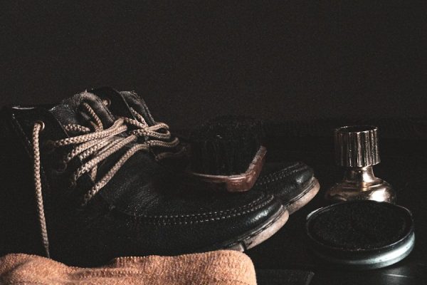 person wearing brown sock and black leather boots